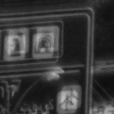 The same road sign through the plate: every symbol and edge appears twice, slightly displaced.