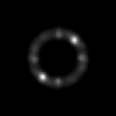 A dark image with a faint ring; two opposite points on the ring are bright.