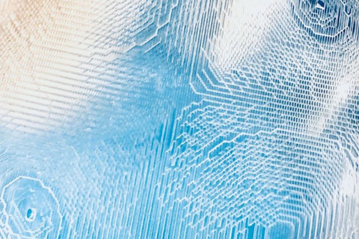 Close-up of a translucent printed relief: fine parallel print lines forming stepped terraces and nested contours.